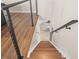 Wooden staircase leading to a lower level, featuring modern black metal railings at 3442 Chestertown Loop, Bradenton, FL 34211