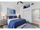 Comfortable bedroom with wood floors, a ceiling fan, and a large abstract painting at 3701 54Th W Dr # 103, Bradenton, FL 34210