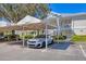 View of a carport with car parked in assigned spot and building exterior in background at 3701 54Th W Dr # 103, Bradenton, FL 34210