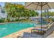 Inviting community pool surrounded by manicured grounds and lounge chairs at 3701 54Th W Dr # 103, Bradenton, FL 34210