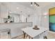 Bright dining area featuring a modern table, stylish chairs, and a view into the kitchen at 3701 54Th W Dr # 103, Bradenton, FL 34210