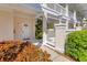 Condo entrance with white door and light fixtures framed by landscaping and privacy fence at 3701 54Th W Dr # 103, Bradenton, FL 34210