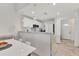 Modern kitchen with white cabinetry, marble countertops, sleek appliances and adjacent dining space at 3701 54Th W Dr # 103, Bradenton, FL 34210
