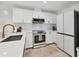 Kitchen with stainless steel appliances, white cabinets and modern countertops at 3701 54Th W Dr # 103, Bradenton, FL 34210