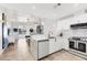 Bright kitchen featuring white cabinetry, stainless steel appliances, and an open design to the living area at 3701 54Th W Dr # 103, Bradenton, FL 34210