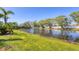 Scenic view of a pond surrounded by lush greenery and a white fence in the background at 3701 54Th W Dr # 103, Bradenton, FL 34210