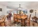 Dining room with a wooden dining table and chairs, chandelier, and sun decor on the wall at 3912 14Th E St, Ellenton, FL 34222