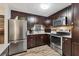 Well-equipped kitchen with stainless steel appliances and dark wood cabinetry at 3912 14Th E St, Ellenton, FL 34222