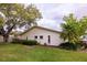 Exterior view of backyard with lush green lawn, mature oak tree, and pristine landscaping at 4018 Oakhurst Dr # 3181, Sarasota, FL 34233