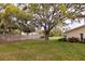 Spacious backyard features a manicured lawn, privacy fence, and shade tree at 4018 Oakhurst Dr # 3181, Sarasota, FL 34233