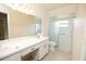 Bathroom with a white vanity featuring double sinks and a shower with patterned sliding doors at 4018 Oakhurst Dr # 3181, Sarasota, FL 34233