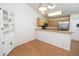 The dining area includes wood floors, overhead lighting, a half wall to the kitchen, and a glass-front hutch at 4018 Oakhurst Dr # 3181, Sarasota, FL 34233