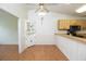 Eat-in kitchen dining area features a ceiling fan, wooden floors, and a decorative hutch for extra storage at 4018 Oakhurst Dr # 3181, Sarasota, FL 34233