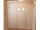 Bright entryway with light walls, wood-look tile floors, and white trim at 4018 Oakhurst Dr # 3181, Sarasota, FL 34233