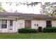 Exterior view of back of home with mature landscaping and green lawn at 4018 Oakhurst Dr # 3181, Sarasota, FL 34233