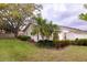 Charming exterior of home with green grass, mature landscaping, and elegant palm trees at 4018 Oakhurst Dr # 3181, Sarasota, FL 34233