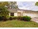 Villa showcasing verdant lawn and shrubbery, an attached two-car garage, and covered entry, exuding curb appeal at 4018 Oakhurst Dr # 3181, Sarasota, FL 34233