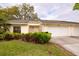 Inviting villa showcasing lush landscaping, a covered entryway, and an attached two-car garage, enhancing curb appeal at 4018 Oakhurst Dr # 3181, Sarasota, FL 34233