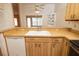 Kitchen features include stainless steel appliances, wood cabinets, a breakfast bar, and wood-look flooring at 4018 Oakhurst Dr # 3181, Sarasota, FL 34233