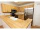 Updated kitchen featuring wood cabinets, stainless steel appliances, and laminate countertops at 4018 Oakhurst Dr # 3181, Sarasota, FL 34233