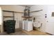 Practical laundry area equipped with a washer, dryer, utility sink, and shelving for storage at 4018 Oakhurst Dr # 3181, Sarasota, FL 34233