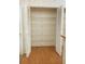 Walk-in pantry featuring ample shelving space and wood-look floors at 4018 Oakhurst Dr # 3181, Sarasota, FL 34233