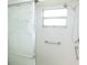 Shower with white tile walls, a grab bar, and a translucent patterned glass door at 4018 Oakhurst Dr # 3181, Sarasota, FL 34233
