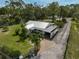 An aerial view of a charming home boasting lush landscaping, mature trees and a long driveway at 4116 34Th E Ave, Bradenton, FL 34208
