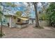 Backyard with a hot tub and above ground pool, surrounded by a brick patio and lush tropical foliage at 4116 34Th E Ave, Bradenton, FL 34208