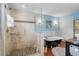 Beautiful bathroom featuring a glass walk-in shower, clawfoot tub, and blue accent wall at 4116 34Th E Ave, Bradenton, FL 34208