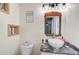 Small bathroom with marble sink and rustic mirror at 4116 34Th E Ave, Bradenton, FL 34208
