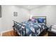 Comfortable bedroom featuring a unique shell-themed bedspread, hardwood floors, and tasteful decor at 4116 34Th E Ave, Bradenton, FL 34208