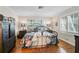 Serene bedroom with wood floors, a large window, and elegant wrought iron bed frame at 4116 34Th E Ave, Bradenton, FL 34208