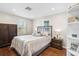 Cozy bedroom with wood floors, a wrought iron bed frame, and abundant natural light at 4116 34Th E Ave, Bradenton, FL 34208
