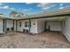 Exterior shot of the carport with brick flooring and green trim, and access to the house entrance at 4116 34Th E Ave, Bradenton, FL 34208