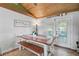 Dining area with a rustic table, bench seating, tile floors, and natural lighting at 4116 34Th E Ave, Bradenton, FL 34208