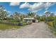 Charming home with a well-maintained front yard, a decorative fence, and a long gravel driveway at 4116 34Th E Ave, Bradenton, FL 34208