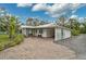 A charming single-story home with a long driveway and an attached carport and garage at 4116 34Th E Ave, Bradenton, FL 34208