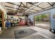Spacious garage with high ceilings, work bench, tool chests, and an open view to the backyard at 4116 34Th E Ave, Bradenton, FL 34208