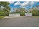 Spacious detached garage with multiple bays and large parking area surrounded by lush greenery at 4116 34Th E Ave, Bradenton, FL 34208