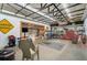 A spacious garage featuring a workshop, a bar, a TV, and roll up doors for flexible use at 4116 34Th E Ave, Bradenton, FL 34208