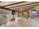 Open garage interior featuring a bar, double doors to the exterior, and ample space for entertaining at 4116 34Th E Ave, Bradenton, FL 34208