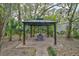Backyard gazebo featuring a covered seating area, plants, and a brick patio for outdoor entertainment at 4116 34Th E Ave, Bradenton, FL 34208