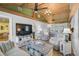 Inviting living room featuring vaulted wood ceilings, comfortable seating, and a large flat-screen television at 4116 34Th E Ave, Bradenton, FL 34208