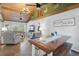 An open-concept living room featuring a wood ceiling, tile floors, and a cozy seating area at 4116 34Th E Ave, Bradenton, FL 34208