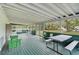 Spacious screened porch with green flooring, ample seating, and a view of the backyard at 4116 34Th E Ave, Bradenton, FL 34208