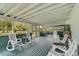 Large screened porch with rocking chairs, offering a relaxing view of the surrounding landscape at 4116 34Th E Ave, Bradenton, FL 34208