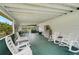 Spacious screened porch with multiple seating arrangements, perfect for outdoor relaxation at 4116 34Th E Ave, Bradenton, FL 34208
