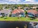 An aerial view showing a pool, lake, and lush greenery in the backyard at 4173 Hearthstone Dr, Sarasota, FL 34238