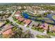 An aerial view shows beautiful waterfront homes with lush landscaping and a well-maintained community at 4173 Hearthstone Dr, Sarasota, FL 34238